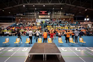 Menschen bewegen sich in einer großen Halle