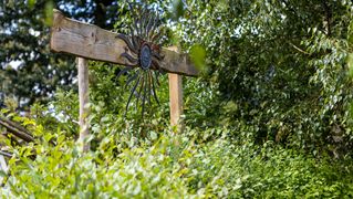 A tin sun on wood adorns the courtyard.